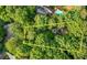 Aerial view of property boundaries in a wooded area with a pool and neighboring houses at 3841 Brooklawn Ne Ct, Brookhaven, GA 30319