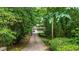 A long driveway leads up to this house, surrounded by lush trees and greenery at 3841 Brooklawn Ne Ct, Brookhaven, GA 30319