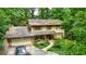 Charming two-story home nestled amongst mature trees with an attached garage and long drive at 3841 Brooklawn Ne Ct, Brookhaven, GA 30319