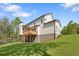 Exterior view of home featuring a spacious backyard, deck, and large windows at 4525 Aiden Way, Cumming, GA 30041