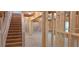 Unfinished basement with exposed beams, staircase, and natural light at 4525 Aiden Way, Cumming, GA 30041