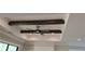 Detailed tray ceiling with exposed wood beams, recessed lighting and a modern ceiling fan at 4525 Aiden Way, Cumming, GA 30041