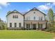 New construction two-story home with white siding, black trim, covered porch, and landscaped front yard at 4525 Aiden Way, Cumming, GA 30041