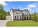 New construction two-story home with white siding, black trim, attached garage, and landscaped front yard at 4525 Aiden Way, Cumming, GA 30041