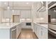 Contemporary kitchen featuring white cabinets, stainless steel appliances, and a center island at 4525 Aiden Way, Cumming, GA 30041