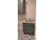 A laundry room with gray cabinets, granite countertops, modern sink fixture and patterned tile flooring at 4525 Aiden Way, Cumming, GA 30041