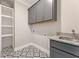 Laundry room featuring patterned floors, gray cabinets, and a utility sink at 4525 Aiden Way, Cumming, GA 30041