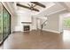 Living room with hardwood floors, fireplace, built-in shelves, beamed ceiling, and sliding glass doors at 4525 Aiden Way, Cumming, GA 30041