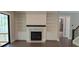 Bright living room with fireplace, built-in shelves, hardwood floors, and access to outdoor balcony at 4525 Aiden Way, Cumming, GA 30041