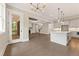 Open concept living area with hardwood floors, modern lighting, and access to a screened porch at 4525 Aiden Way, Cumming, GA 30041