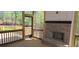 Covered patio with brick fireplace and screened windows offering natural light and fresh air at 4525 Aiden Way, Cumming, GA 30041
