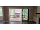 View from inside home looking out to a screened in porch featuring a brick fireplace and wood flooring at 4525 Aiden Way, Cumming, GA 30041