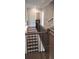 Elegant staircase with wooden steps and iron railing leading downstairs at 4525 Aiden Way, Cumming, GA 30041