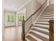 Foyer with staircase, hardwood floors, and a glass paneled front door that provides natural light at 4525 Aiden Way, Cumming, GA 30041