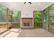 Screened-in sunroom with wood floors, wood burning fireplace, and plenty of natural light at 4525 Aiden Way, Cumming, GA 30041