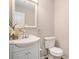 Well-maintained half bathroom featuring a vanity sink and toilet at 573 Hastings Way, Jonesboro, GA 30238