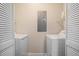 Functional laundry room with washer and dryer hookups and shelving for storage at 573 Hastings Way, Jonesboro, GA 30238