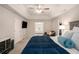 The main bedroom features a tray ceiling, lots of natural light, a TV, and a comfortable sitting area at 573 Hastings Way, Jonesboro, GA 30238
