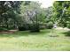 Wide shot of the backyard that also captures some of the trees and the house at 127 Perry St, Loganville, GA 30052