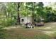 Exterior shot of the shed in the backyard surrounded by mature trees and foliage at 127 Perry St, Loganville, GA 30052