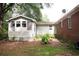 Backyard view showcasing the house, with different siding, and a small garden area at 127 Perry St, Loganville, GA 30052