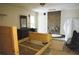 Bedroom featuring a brick fireplace, a wooden bed frame and unfinished flooring at 127 Perry St, Loganville, GA 30052