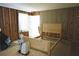 Bedroom showing the bed frame, window, and some of the unfinished walls at 127 Perry St, Loganville, GA 30052