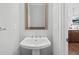 Bathroom with pedestal sink, a mirror and modern fixtures at 1858 Glenview Park Cir, Duluth, GA 30097
