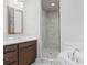 Bathroom with double sink vanity, tile floors, and marble shower with glass door at 1858 Glenview Park Cir, Duluth, GA 30097