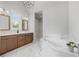 Luxury bathroom featuring double vanity, marble floors, and tub next to a marble shower at 1858 Glenview Park Cir, Duluth, GA 30097