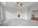 Bright bedroom showcasing neutral paint, carpeted floor, and doorway leading to a bathroom at 1858 Glenview Park Cir, Duluth, GA 30097