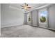 Inviting bedroom with large windows, carpet flooring, and tray ceiling with ceiling fan at 1858 Glenview Park Cir, Duluth, GA 30097