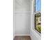 Cozy walk-in closet with wire shelving and a window overlooking a neighboring house at 1858 Glenview Park Cir, Duluth, GA 30097