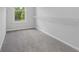 A walk-in closet showcasing carpeted floors, neutral walls and a window at 1858 Glenview Park Cir, Duluth, GA 30097