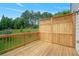 A spacious wooden deck with railing overlooks lush greenery, perfect for outdoor living at 1858 Glenview Park Cir, Duluth, GA 30097