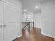 Hallway with dark wood floors and wood-and-wrought-iron staircase at 1858 Glenview Park Cir, Duluth, GA 30097