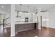 Open kitchen with island and stainless appliances with staircase at 1858 Glenview Park Cir, Duluth, GA 30097
