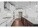 Modern kitchen boasts stainless appliances, a large island with granite countertops, and white cabinetry at 1858 Glenview Park Cir, Duluth, GA 30097