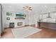 Open-concept living room with fireplace, hardwood floors, and easy access to the modern kitchen at 1858 Glenview Park Cir, Duluth, GA 30097