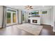 Inviting living room featuring a fireplace, hardwood floors, and access to the outdoor deck at 1858 Glenview Park Cir, Duluth, GA 30097
