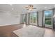 Spacious living room with hardwood floors, large windows with view and access to the outdoor deck at 1858 Glenview Park Cir, Duluth, GA 30097