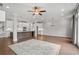 Bright open-concept living room with hardwood floors and view into the modern kitchen at 1858 Glenview Park Cir, Duluth, GA 30097