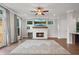 Bright living room featuring a fireplace, hardwood floors, and access to the outdoor deck at 1858 Glenview Park Cir, Duluth, GA 30097