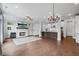 Open concept living room with fireplace, hardwood floors, and view to the modern kitchen at 1858 Glenview Park Cir, Duluth, GA 30097