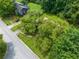 Aerial view showcases the home and surrounding neighborhood, lush greenery, and street at 2930 Heather Stone Way, Lawrenceville, GA 30043