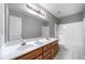 Bathroom features double sink vanity, large mirror, and shower-tub combo at 2930 Heather Stone Way, Lawrenceville, GA 30043