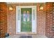 Elegant front door with decorative glass inserts and sidelights framed by sconces at 2930 Heather Stone Way, Lawrenceville, GA 30043