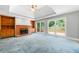 Bright living room features a fireplace, built-ins, and expansive windows leading to deck at 2930 Heather Stone Way, Lawrenceville, GA 30043
