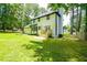 Well-maintained backyard and lawn with mature trees and patio at 3139 Fairview Dr, Snellville, GA 30078