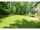 Expansive lawn with mature trees surrounding the backyard at 3139 Fairview Dr, Snellville, GA 30078